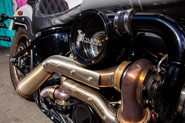 Turbine housing and mandrel bent stainless pipework of the Trask Tornado Turbo Kit low on the right side of the bike